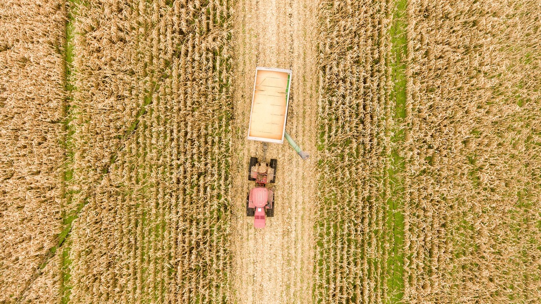 Image of a tractor driving through a field.