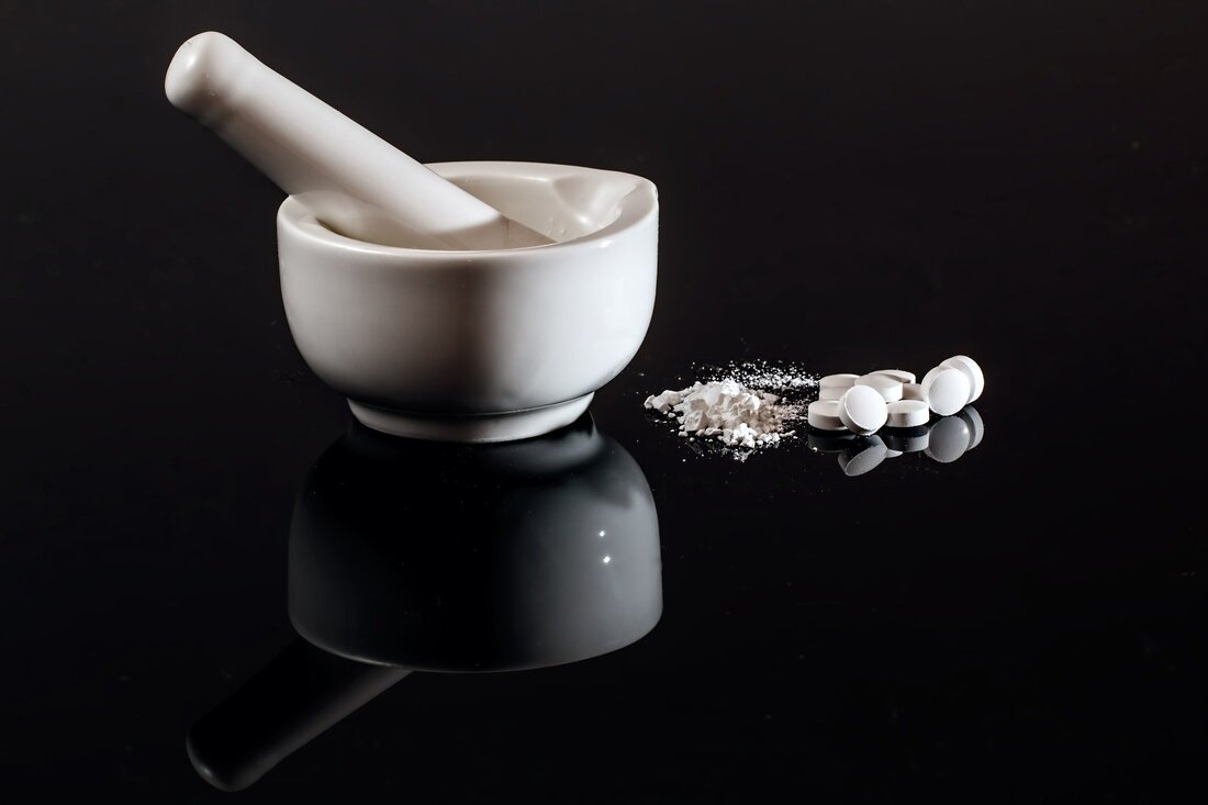 Image of a mortar and pestle with crushed pills