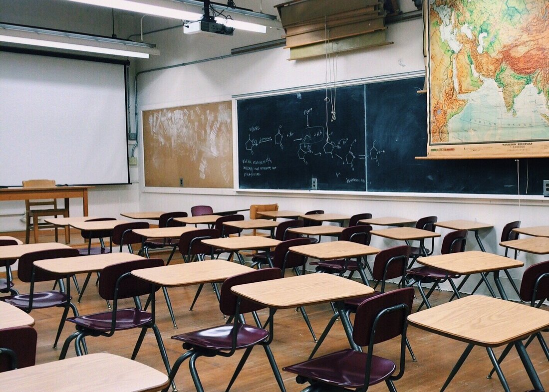 Image of an empty classroom with chairs and desks