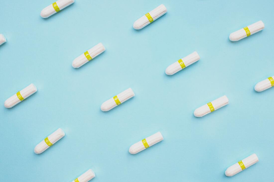 Image of tampons in a row on a light blue background