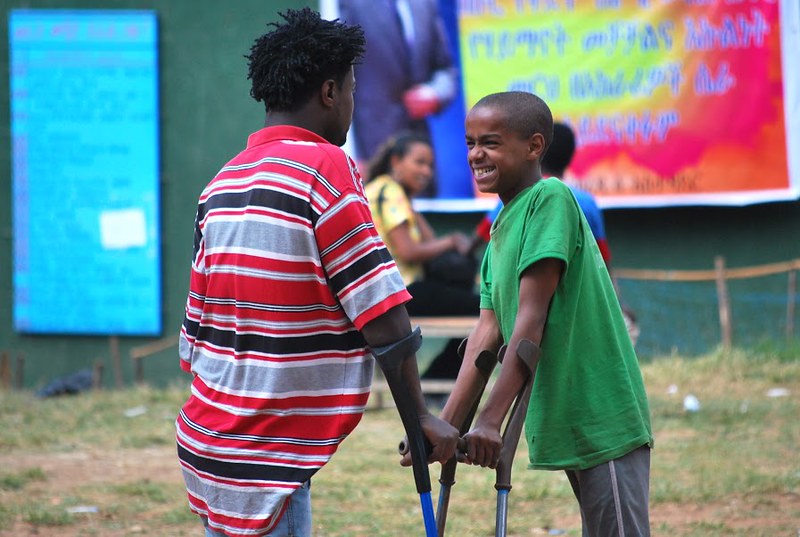 Image of two boys at school in Ethopia using crutches.