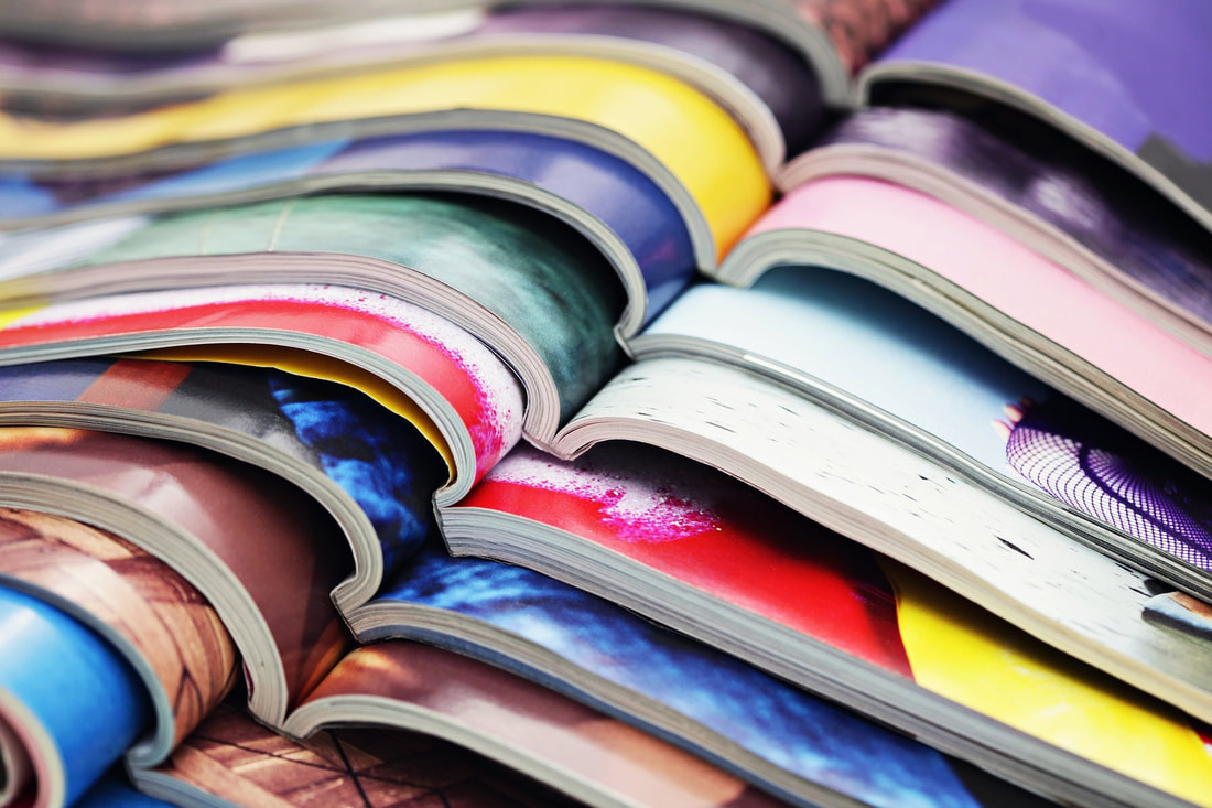 Image of stacked magazines opened