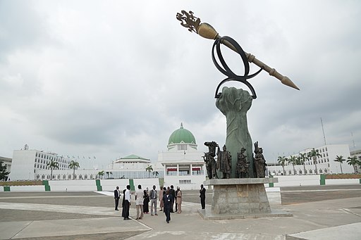 Image of Nigeria's National Assembly Building in the background with the Mace statue in the foreground